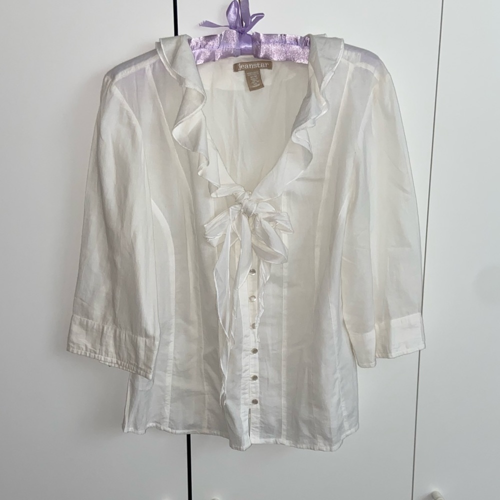 White button down shirt with bow tie at the top